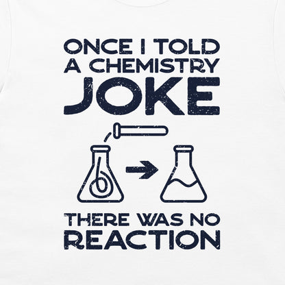 A white graphic print on a garment featuring the text 'ONCE I TOLD A CHEMISTRY JOKE THERE WAS NO REACTION' in distressed dark navy lettering, with simple beaker illustrations and an arrow in the center.
