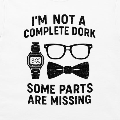 A close-up of a white blue t-shirt featuring a black distressed graphic that reads 'I'M NOT A COMPLETE DORK SOME PARTS ARE MISSING' with illustrations of a digital watch, eyeglasses, and a bow tie.