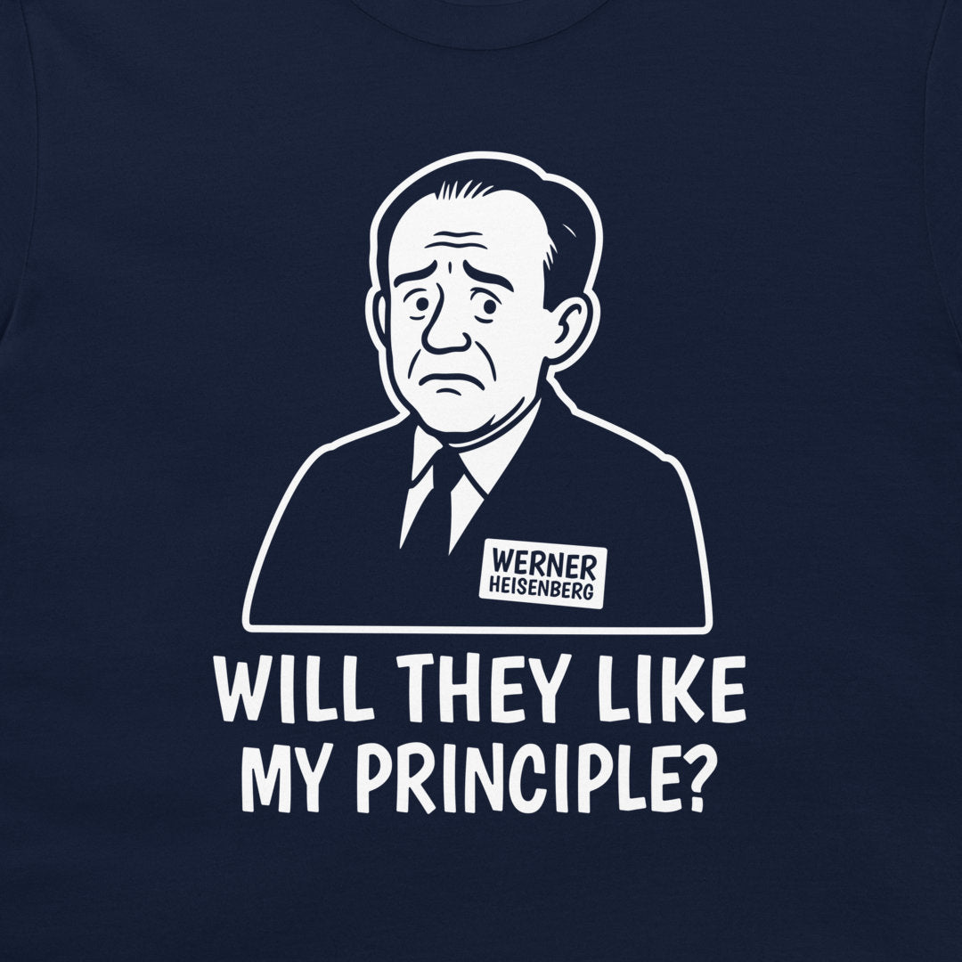 A close-up of a navy blue t-shirt featuring a white graphic print of a caricature portrait of Werner Heisenberg with a name tag and the text 'WILL THEY LIKE MY PRINCIPLE?' printed below.