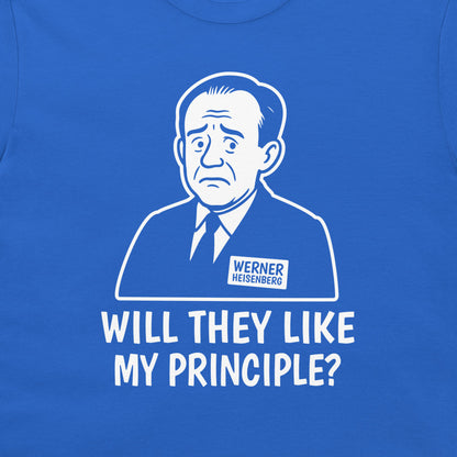 A close-up of a royal blue t-shirt featuring a white graphic print of a stern man in a suit with a 'Werner Heisenberg' name tag, and the text 'WILL THEY LIKE MY PRINCIPLE?' printed below.