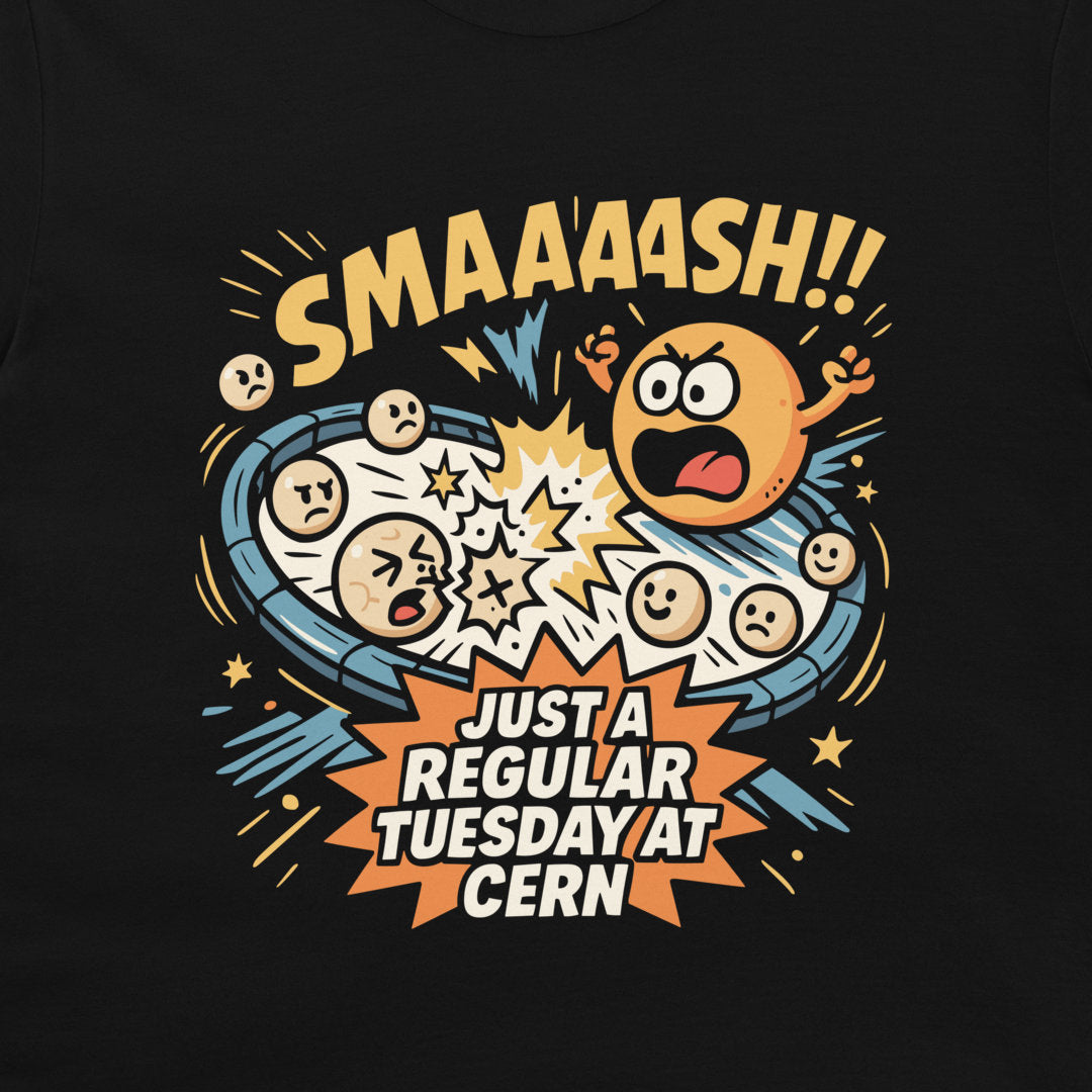 A close-up of a black t-shirt featuring a colorful graphic print. The design shows a cartoon explosion with various facial expressions, the text 'SMAAAASH!!' in yellow at the top, and 'JUST A REGULAR TUESDAY AT CERN' in white inside an orange burst at the bottom.