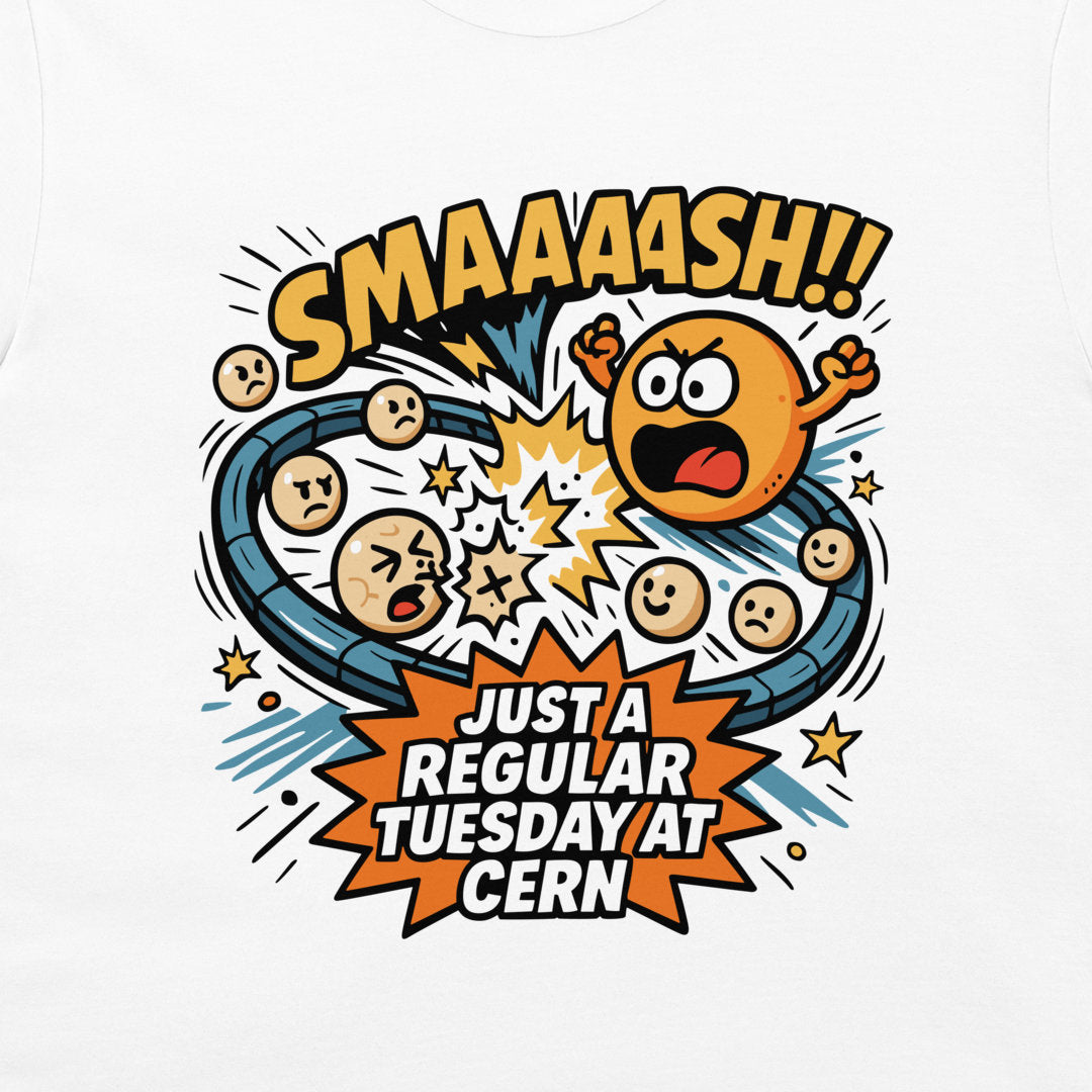 A close-up of a white garment, likely a t-shirt, featuring a colorful graphic print. The design is a comic-style illustration with the text 'SMAAAASH!!' and 'JUST A REGULAR TUESDAY AT CERN', depicting cartoon emoji faces on a blue circular track with an orange explosion.