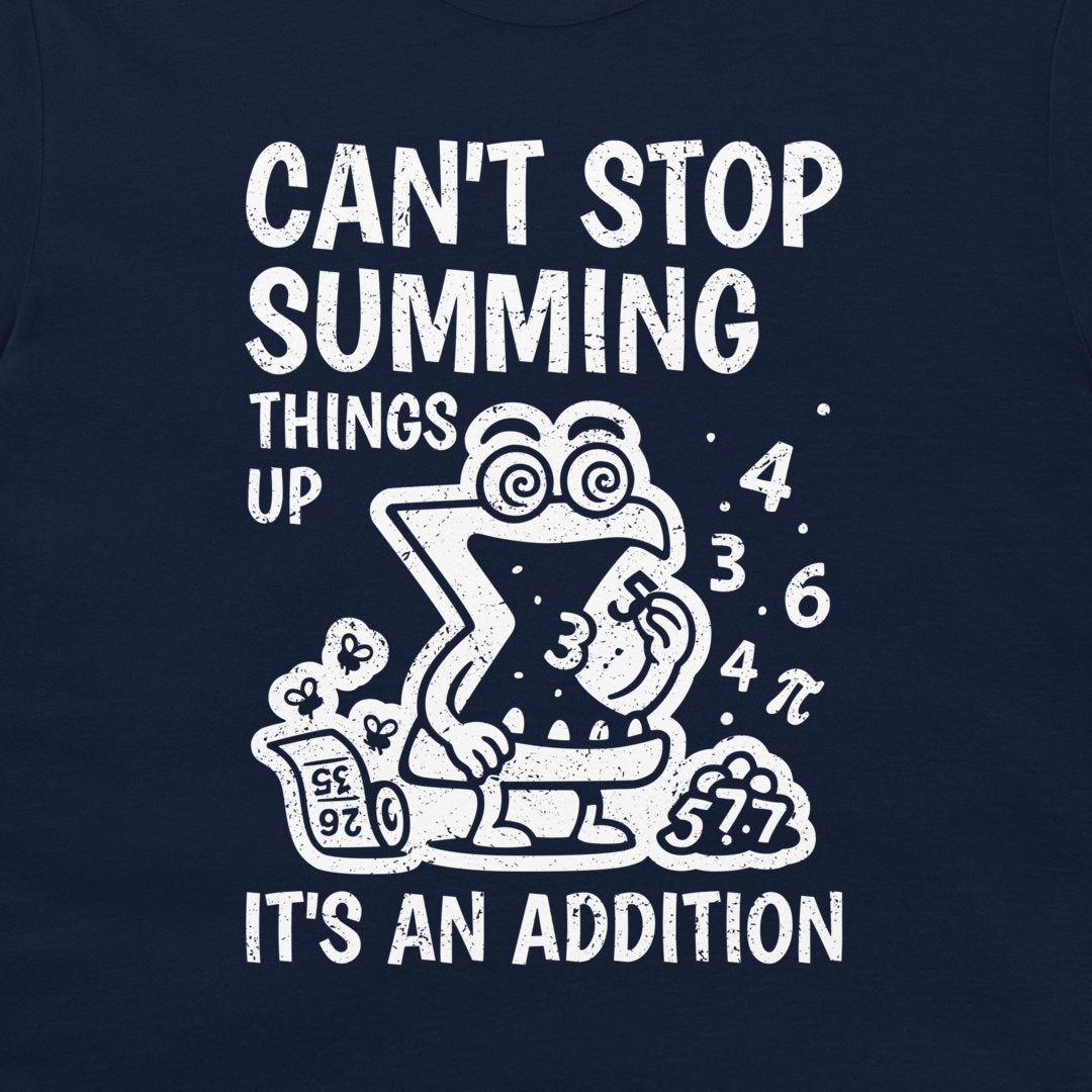 A close-up of a navy blue t-shirt, featuring a white distressed graphic print. The graphic displays a cartoon frog sitting inside a Sigma symbol, surrounded by mathematical equations and numbers, with the text 'CAN'T STOP SUMMING THINGS UP' and 'IT'S AN ADDITION'.