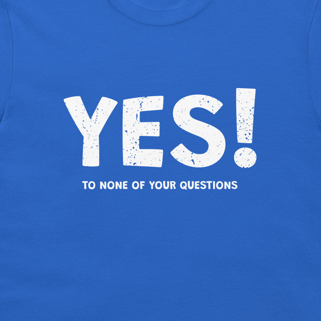 A close-up of a bright blue t-shirt featuring a white distressed graphic that reads 'YES!' in large letters with 'TO NONE OF YOUR QUESTIONS' printed underneath.