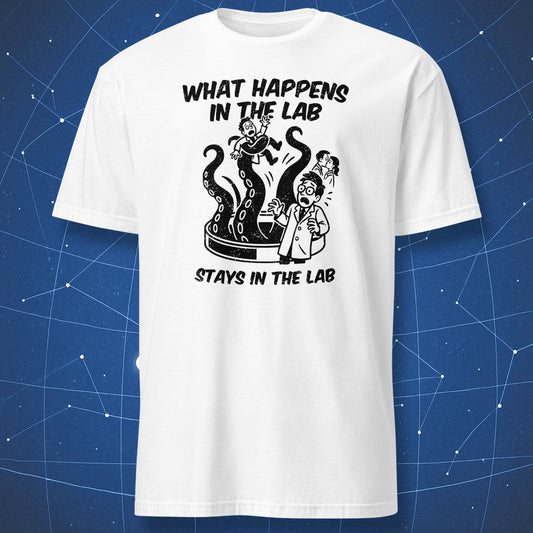 White T-shirt with black outlined design of a lab experiment gone wrong — tentacled monster and scientist under “What Happens in the Lab Stays in the Lab.”