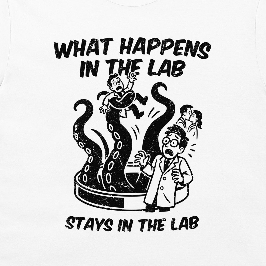 A white graphic t-shirt featuring a black cartoon illustration of a scientist in a lab coat surrounded by a giant octopus tentacle, with the text 'WHAT HAPPENS IN THE LAB STAYS IN THE LAB'.