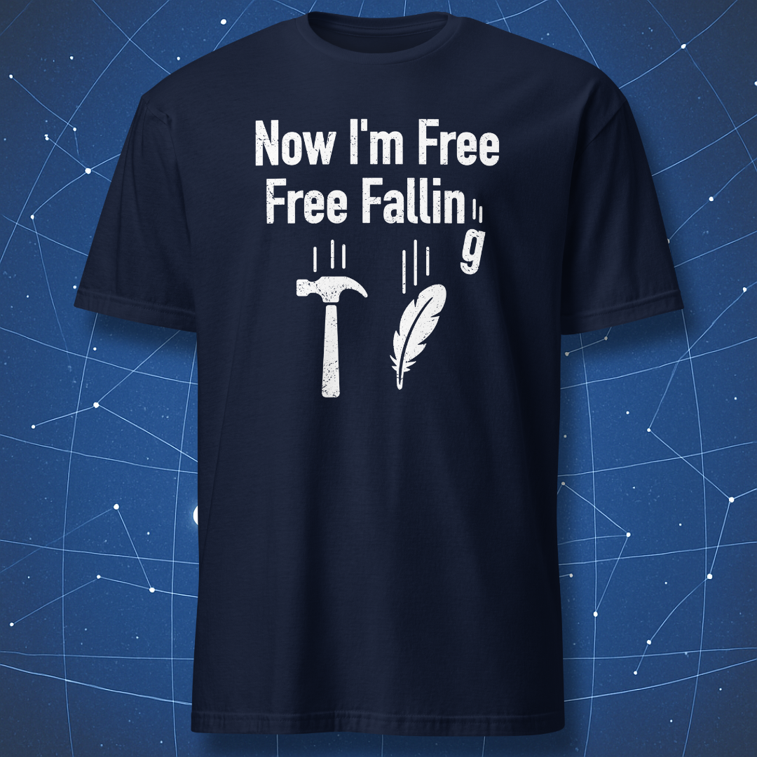 Navy T-shirt showing a hammer, feather, and falling g symbol under “Now I’m free, free fallin’ g” — clever science pun shirt.