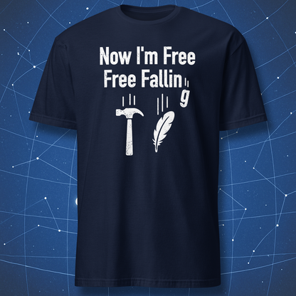 Navy T-shirt showing a hammer, feather, and falling g symbol under “Now I’m free, free fallin’ g” — clever science pun shirt.