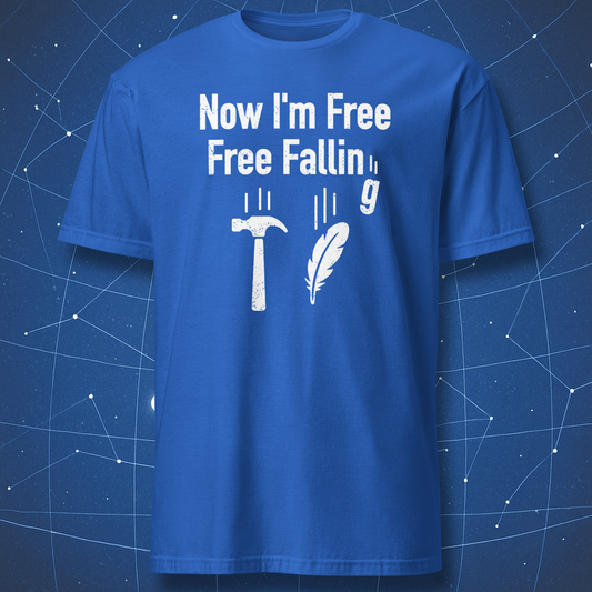 Royal blue T-shirt with white distressed text “Now I’m free, free fallin’ g” and falling hammer, feather, and g icons — fun physics joke design.