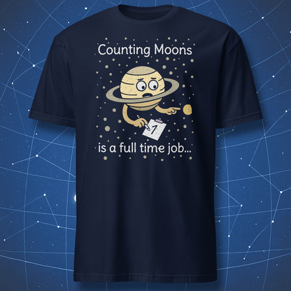 Navy blue T-shirt showing a funny Saturn character counting its moons with the phrase “Counting Moons is a full time job” — cute astronomy humor tee.