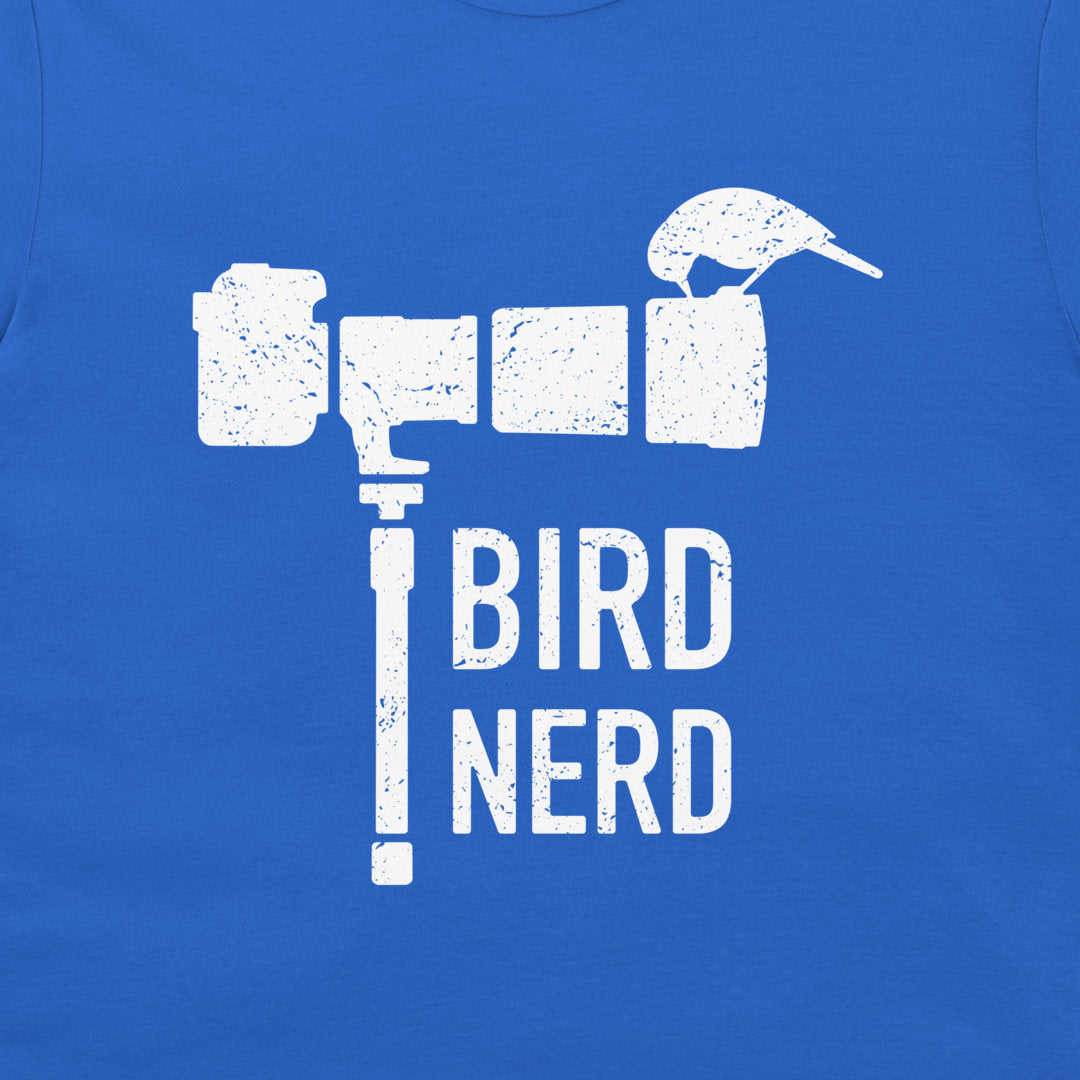 A close-up of a blue T-shirt featuring a distressed white graphic that reads 'TROLL BIRD NERD' with a bird silhouette integrated into the design.