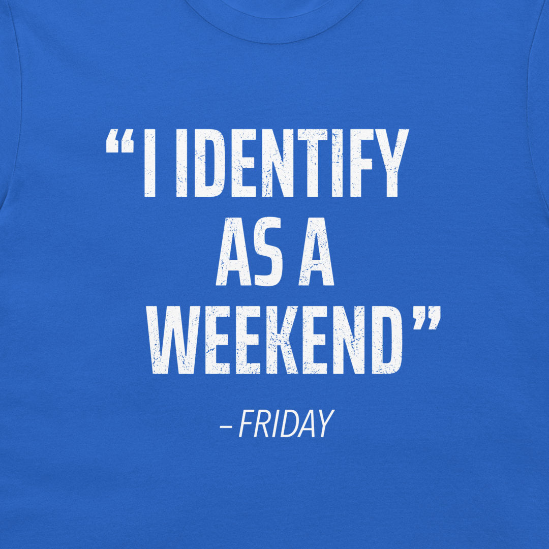 A close-up of a blue t-shirt featuring a distressed white typographic print that reads “I IDENTIFY AS A WEEKEND” with “- FRIDAY” underneath.