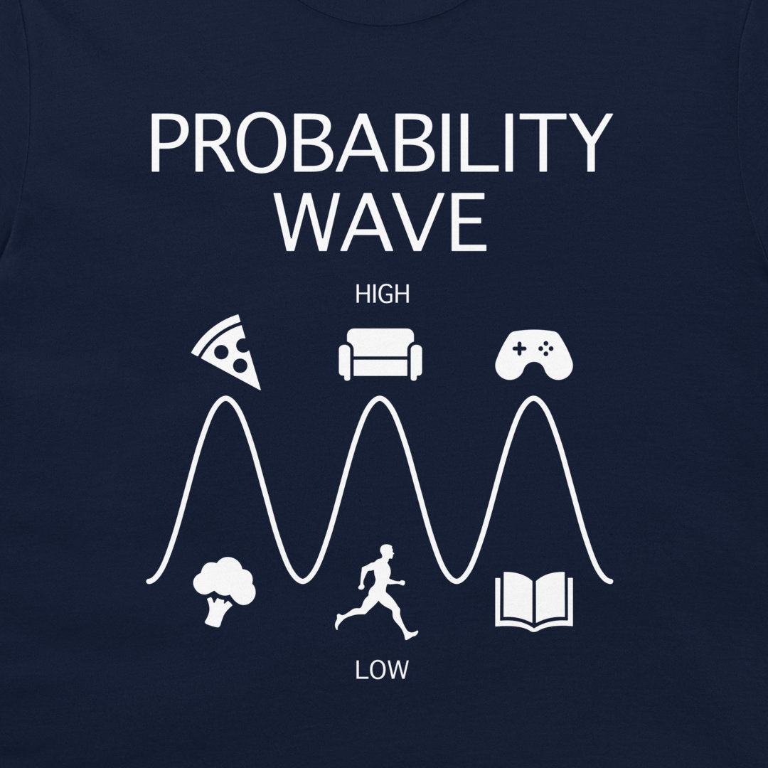 A close-up of a navy blue t-shirt, featuring a white graphic print titled 'PROBABILITY WAVE'. The design shows a wave with peaks and troughs, labeled 'HIGH' and 'LOW', with various icons representing activities like pizza, a couch, video games, broccoli, a runner, and a book.