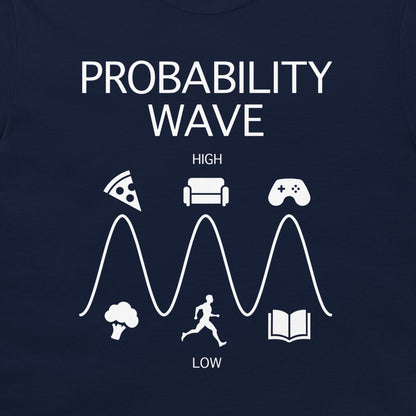 A close-up of a navy blue t-shirt, featuring a white graphic print titled 'PROBABILITY WAVE'. The design shows a wave with peaks and troughs, labeled 'HIGH' and 'LOW', with various icons representing activities like pizza, a couch, video games, broccoli, a runner, and a book.