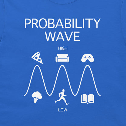 A close-up of a blue T-shirt featuring a white graphic print titled 'PROBABILITY WAVE' with icons for pizza, couch, game controller, broccoli, running figure, and book arranged above and below a wave labeled HIGH and LOW.