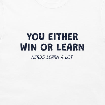 A close-up of a white t-shirt featuring a navy blue  printed graphic that reads 'YOU EITHER WIN OR LEARN' with 'NERDS LEARN A LOT' underneath.