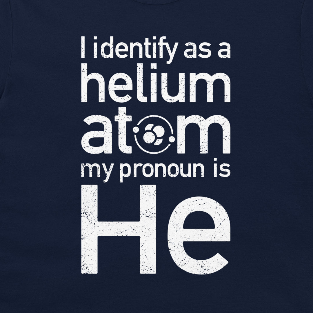 A close-up of a navy blue t-shirt featuring a distressed white graphic print that reads 'I identify as a helium atom my pronoun is He'.