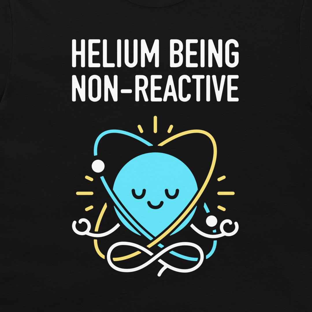 A black graphic t-shirt featuring a light blue cartoon planet with a smiling face inside a yellow and white orbit around the text 'HELIOM Being NON-REACTIVE' in white capital letters.