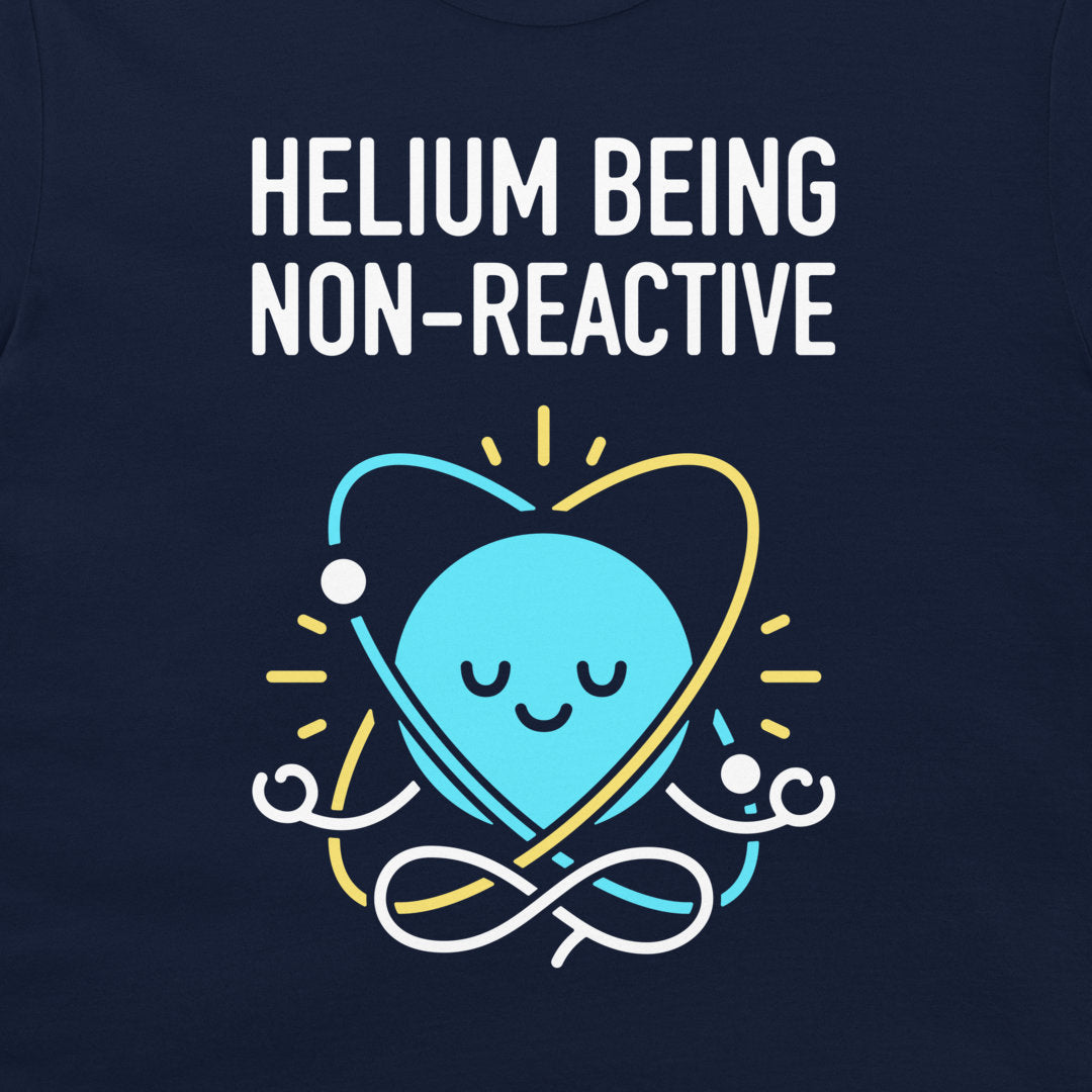 A close-up of a navy blue shirt featuring a graphic design. The design displays the text 'HELIOM BEING NON-REACTIVE' in white capital letters above a cute, smiling light blue cartoon atom meditating in a white and yellow infinity loop.