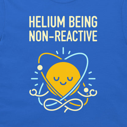 A close-up of a blue T-shirt featuring a graphic design. The design displays the text 'HELIOM Being NON-REACTIVE' in a cream-colored retro font, with a yellow meditating sun atom symbol below it in yellow, light blue, and white.