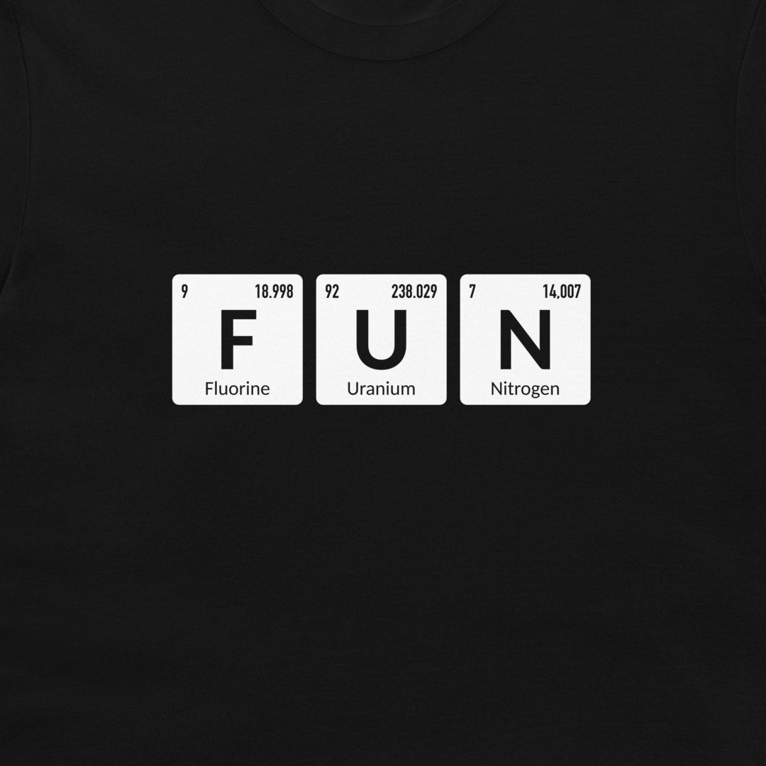 A close-up of a black t-shirt, featuring a white graphic print of three periodic table style tiles spelling out 'FUN' with 'Fluorine', 'Uranium', and 'Nitrogen' written below each letter.