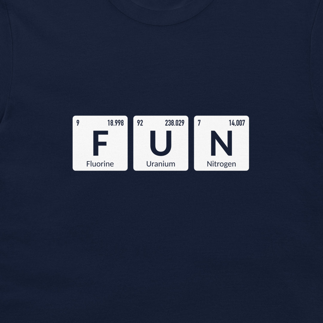 A close-up of a navy blue t-shirt featuring a graphic of three white periodic table style tiles spelling out 'FUN' with 'Fluorine', 'Uranium', and 'Nitrogen' printed on them.
