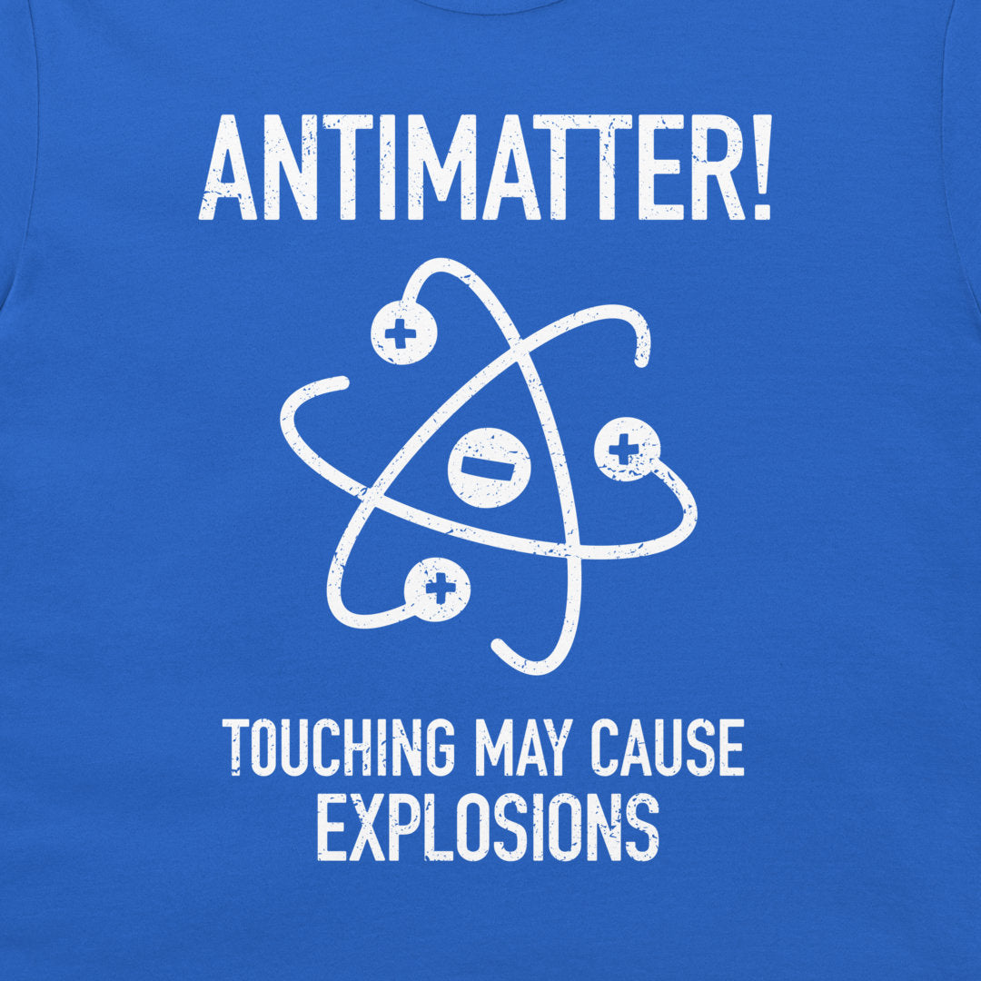 A close-up of a blue T-shirt with a white distressed graphic and text reading 'ANTIMATTER!' and 'TOUCHING MAY CAUSE EXPLOSIONS' around an atom symbol.