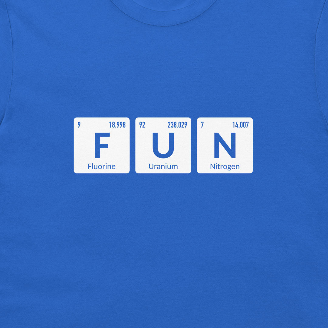A close-up of a royal blue t-shirt featuring a graphic of three white periodic table style tiles spelling out 'FUN' with 'Fluorine', 'Uranium', and 'Nitrogen' printed on them.