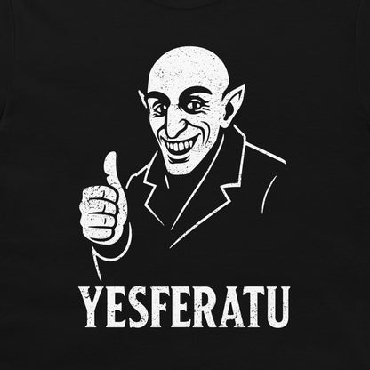 A close-up of a black t-shirt, featuring a white distressed graphic of a bald man with pointed ears giving a thumbs-up, with the text 'YESFERATU' printed below.