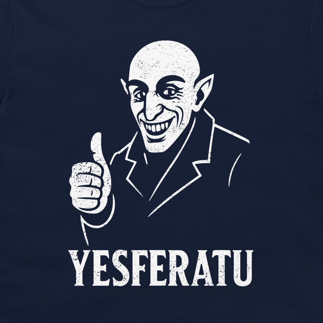 A close-up of a navy blue t-shirt featuring a white distressed graphic of a bald, pointed-eared character giving a thumbs-up, with the text 'YESFERATU' printed below.