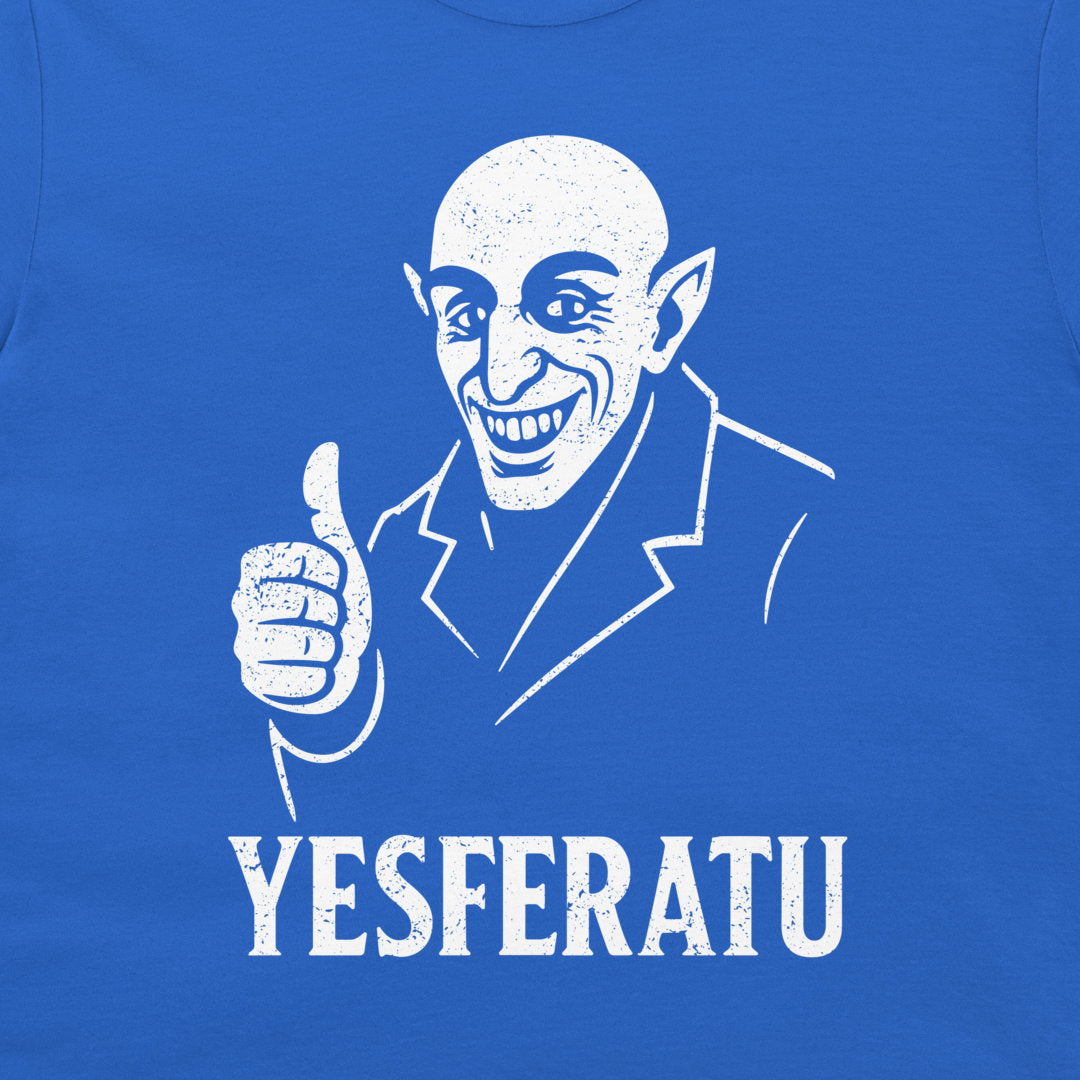 A close-up of a navy blue t-shirt featuring a white distressed graphic of a bald, pointed-eared character giving a thumbs-up, with the text 'YESFERATU' printed below.