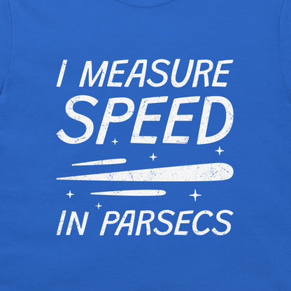 A close-up of a blue t-shirt featuring a white distressed graphic that reads 'I MEASURE SPEED IN PARSECS' with a stylized streak and stars.