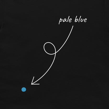 A close-up of a black T-shirt, featuring a white hand-drawn style arrow pointing from the text 'pale blue' to a small light blue dot.
