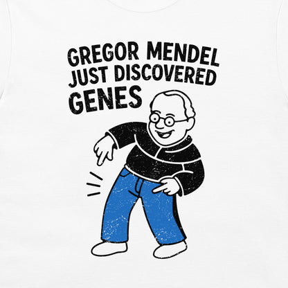 A white graphic t-shirt featuring a cartoon illustration of Gregor Mendel with the text 'GREGOR MENDEL JUST DISCOVERED GENES' in a distressed black font.