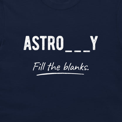 A close-up of a navy blue t-shirt featuring a white graphic print that reads 'ASTRO___Y' in a distressed sans-serif font, with 'Fill the blanks.' written below in a cursive script, underlined with a white hand-drawn stroke.