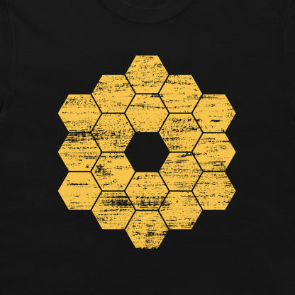 A close-up of a black garment, likely a t-shirt, featuring a distressed yellow honeycomb hexagon graphic in the center.