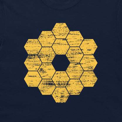 A close-up of a navy blue garment, likely a t-shirt, featuring a distressed yellow hexagonal honeycomb pattern in the center.