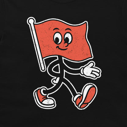 A black t-shirt featuring a distressed graphic of a walking red flag mascot with a smiling face, white stick figure limbs, and red-and-white sneakers.