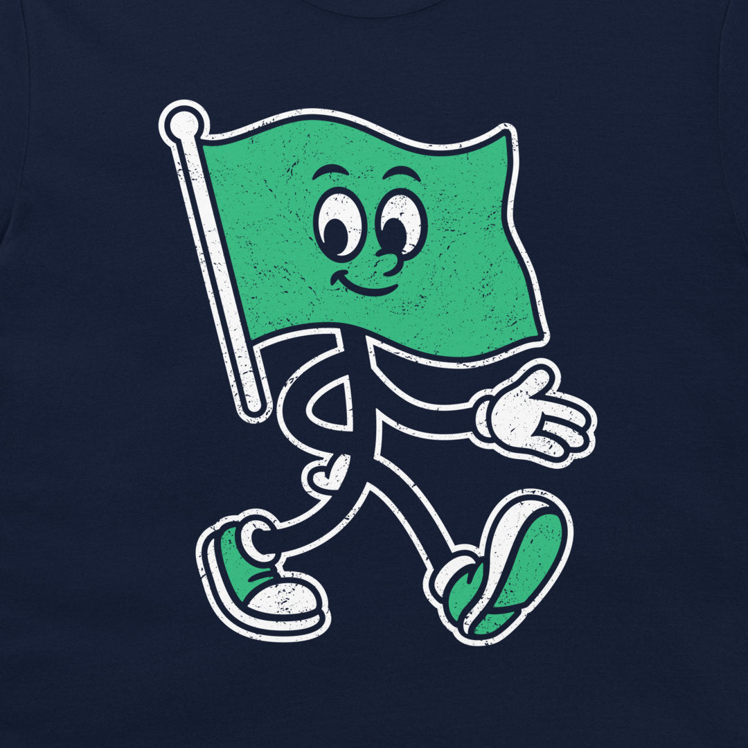 A navy blue t-shirt featuring a cartoon graphic of a waving green flag character with a smiling face, black limbs, and white sneakers.