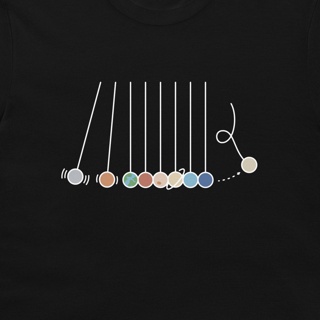 A close-up of a black t-shirt, featuring a white graphic of a Newton's cradle with colorful beads.