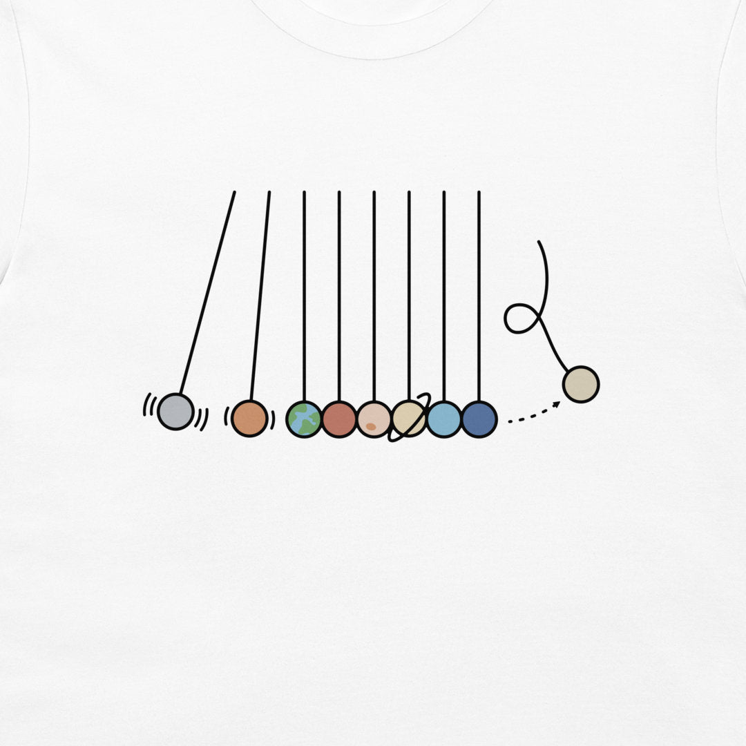 A close-up of a white t-shirt, featuring a printed graphic of a Newton's cradle with colorful planet-like beads.