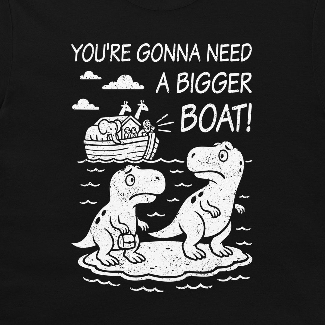 A black t-shirt featuring a white graphic print of two cartoon dinosaurs on a small island, with Noah's Ark in the background and the text 'YOU'RE GONNA NEED A BIGGER BOAT!'.