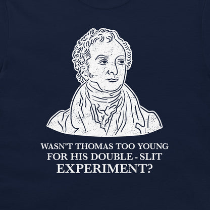 A navy blue t-shirt featuring a white graphic print of a historical portrait of Thomas Young, with the text 'WASN'T THOMAS TOO YOUNG FOR HIS DOUBLE - SLIT EXPERIMENT?' printed below.