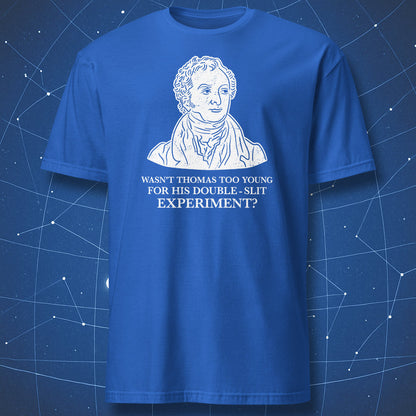 A close-up of a blue t-shirt featuring a white graphic print of a historical portrait of Thomas Jefferson with the text 'WASN'T THOMAS TOO YOUNG FOR HIS DOUBLE - SLIT EXPERIMENT?' printed below.