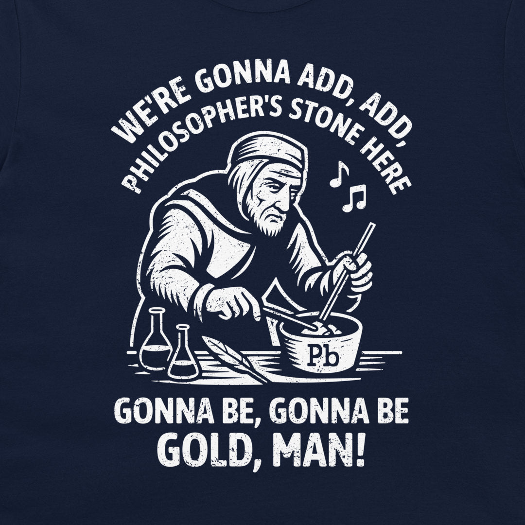 A navy blue t-shirt featuring a white graphic print of a philosopher mixing gold powder in a bowl, with the text 'WE'RE GONNA ADD, ADD, PHILOSOPHER'S STONE HERE' and 'GONNA BE, GONNA BE GOLD, MAN!'.