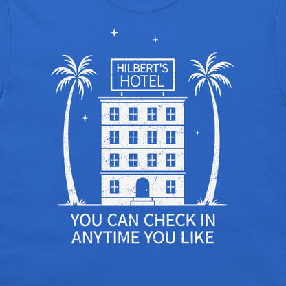 A blue t-shirt featuring a white graphic print of a building labeled 'HILBERT'S HOTEL' with two palm trees and the text 'YOU CAN CHECK IN ANYTIME YOU LIKE'.
