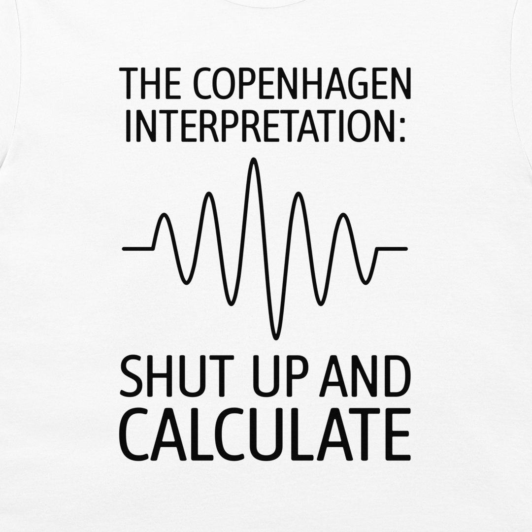 White t-shirt featuring a black graphic print with the text 'THE COPENHAGEN INTERPRETATION:' and 'SHUT UP AND CALCULATE' surrounding a simple soundwave line diagram.