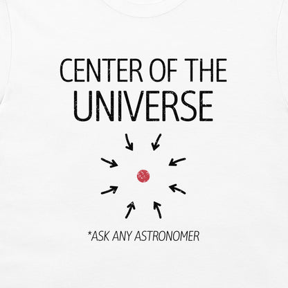 White t-shirt featuring a black graphic print that reads 'CENTER OF THE UNIVERSE' with arrows pointing toward a small red dot, and the text '*ASK ANY ASTRONOMER' below.