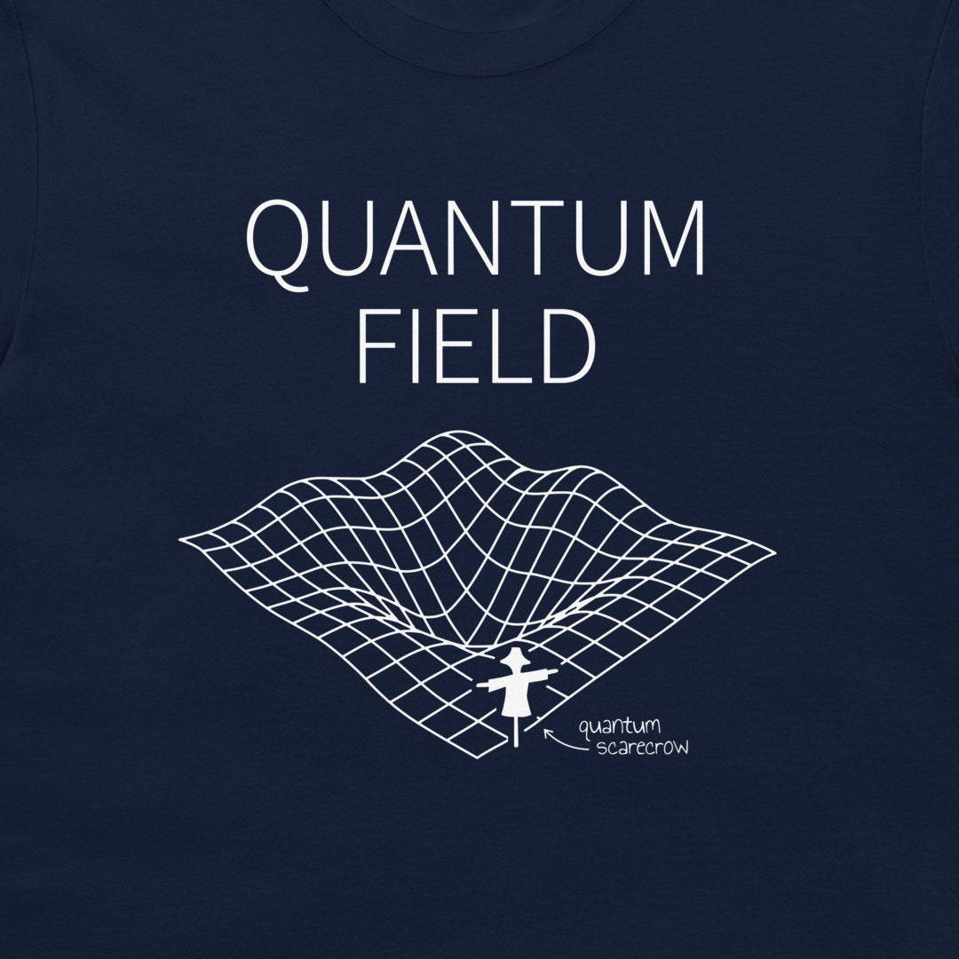 A close-up of a navy blue t-shirt featuring a white graphic print with the text 'QUANTUM FIELD' and a 3D grid illustration of a wormhole with a small figure labeled 'quantum scarcrow'.
