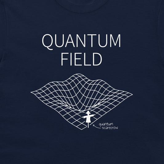 A close-up of a navy blue t-shirt featuring a white graphic print with the text 'QUANTUM FIELD' and a 3D grid illustration of a wormhole with a small figure labeled 'quantum scarcrow'.
